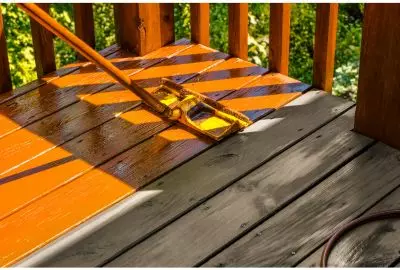 a wooden deck and Port St Lucie being stained with amber hue