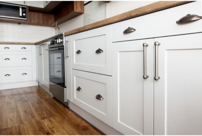 Freshly painted white kitchen cabinets, comparing cabinet painting vs refacing in Port St Lucie